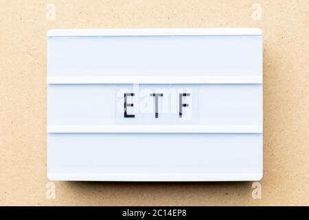 White lightbox with word ETF (abbreviation of Exchange Traded Fund) on wood background Stock Photo