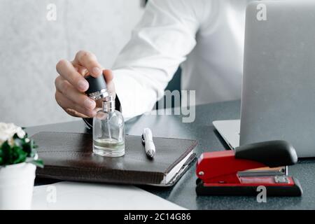 Businessman in home office holding stapler and documents isolated on white background. Professional using laptop and smart phone in the office Stock Photo