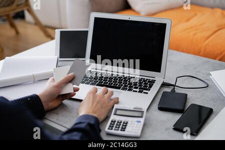 Businessman is using laptop and analysing the financial information at his office. Close up of male hands typing on computer keyboard. Stock Photo