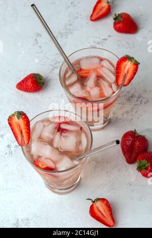 Two strawberry lemonade with ice and berries on a light background. Top view Stock Photo