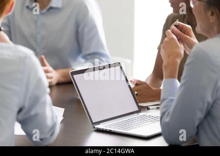 Businesswoman using laptop with mock up screen at briefing Stock Photo