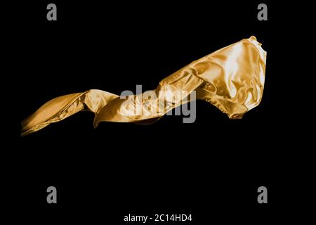 golden soft satin flying in wind on background Stock Photo