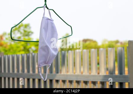 The cloth mask hanging.Hand made cotton cloth face mask are drying. Home made reusable face mask after washing. Stock Photo