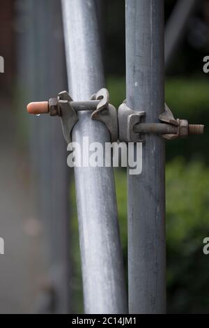 Scaffolding pipe clamp and parts: an important part of building strength to scaffold clamps in used close up on construction site Stock Photo