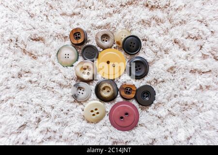 clothing buttons isolated on furry carpet Stock Photo