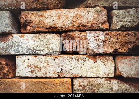 Pattern of decorative natural stone wall with stones in several colors, red, ancient color with modern style of stone, red, yellow stone to light Stock Photo
