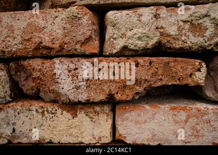 Pattern of decorative natural stone wall with stones in several colors, red, ancient color with modern style of stone, red, yellow stone to light Stock Photo