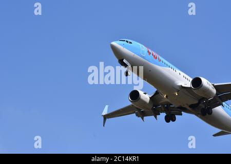 A TUI aeroplane in the sky at Bristol International Airport, UK - With a gorgeous blue background (26th of July 2018) Stock Photo