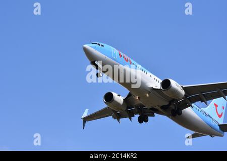 A TUI aeroplane in the sky at Bristol International Airport, UK - With a gorgeous blue background (26th of July 2018) Stock Photo