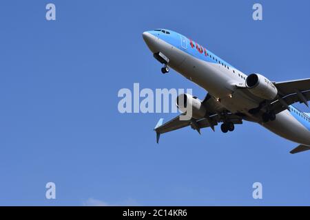 A TUI aeroplane in the sky at Bristol International Airport, UK - With a gorgeous blue background (26th of July 2018) Stock Photo