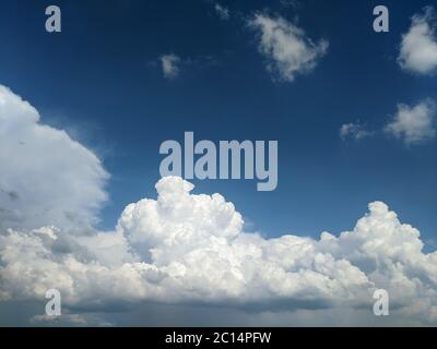Fluffy clouds in blue sky on a summer day Stock Photo