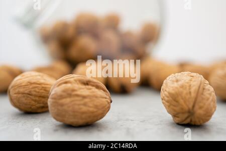 Glass jar filled with healthy walnut kernels whole walnuts.The perfect health fat and good carbohydrate to provide nutrition! Vintage bowl. Stock Photo