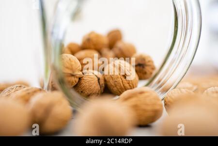 Glass jar filled with healthy walnut kernels whole walnuts.The perfect health fat and good carbohydrate to provide nutrition! Vintage bowl. Stock Photo