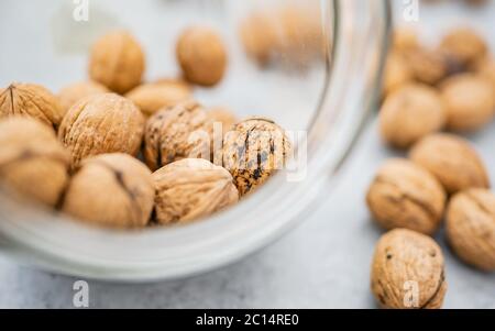 Concept healthy walnut kernels in a glass bowl. Good carbohydrate to provide nutrition! Illuminated with natural light. Stock Photo