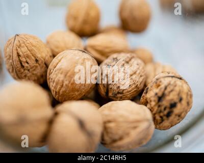 Glass jar filled with healthy walnut kernels whole walnuts.The perfect health fat and good carbohydrate to provide nutrition! Vintage bowl. Stock Photo