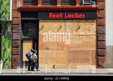 A shuttered, boarded up, closed Foot Locker shoe store storefront in New York Stock Photo