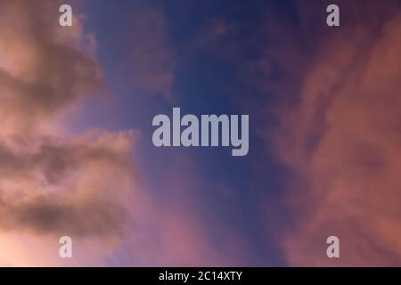 A sky in beautiful colors at sunset with a few clouds Stock Photo