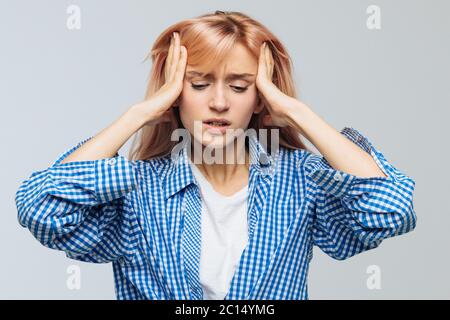 Pressure, strong migraine, feeling dizzy, nerves concept. Portrait of furious or stressful teen woman has a headache, tries to concentrate, gather wit Stock Photo