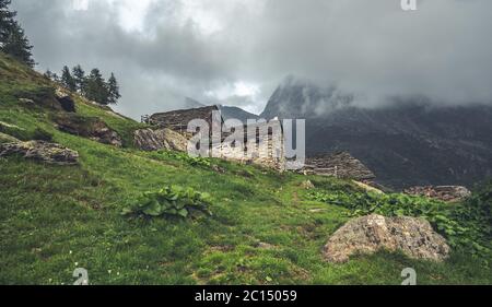 Abandoned building high in alpine mountains Stock Photo
