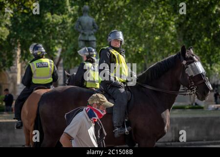 London, UK. 13th June, 2020. Thousands of nationalist, far-right and football lad supporters gather in Westminster to protest against the recent removal and covering of statues and memorials, notably Winston Churchill in Parliament Square. Police and press where frequently attacked with over 100 recorded arrests. Credit: Guy Corbishley/Alamy Live News Stock Photo