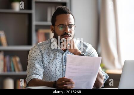 African male lawyer read contract details feels discontented concept Stock Photo