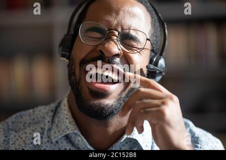 African guy singing song wearing headset closeup portrait Stock Photo
