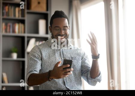African man holding smartphone read message feels excited Stock Photo
