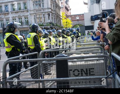 Riot police in Whitehall behind barriers, preventing Britain First far right supporters clashing with Black Lives Matter anti-racism protesters. Stock Photo