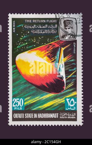 One of a set of seven Vintage cancelled postage stamp from Quaiti State or South Arabia. Stamp Circa 1969 featuring scenes of the exploration of space Stock Photo