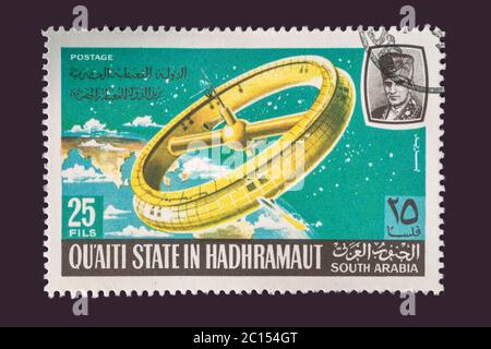 One of a set of seven Vintage cancelled postage stamp from Quaiti State or South Arabia. Stamp Circa 1969 featuring scenes of the exploration of space Stock Photo