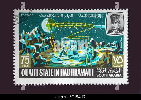 One of a set of seven Vintage cancelled postage stamp from Quaiti State or South Arabia. Stamp Circa 1969 featuring scenes of the exploration of space Stock Photo