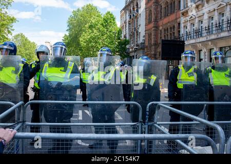 Riot police in Whitehall behind barriers, preventing Britain First far right supporters clashing with Black Lives Matter anti-racism protesters. Stock Photo