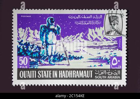 One of a set of seven Vintage cancelled postage stamp from Quaiti State or South Arabia. Stamp Circa 1969 featuring scenes of the exploration of space Stock Photo