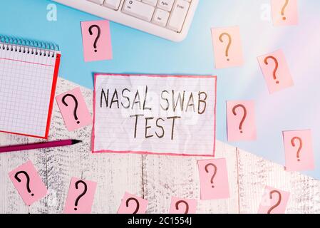 Handwriting text Nasal Swab Test. Conceptual photo diagnosing an upper respiratory tract infection through nasal secretion Writing tools, computer stu Stock Photo