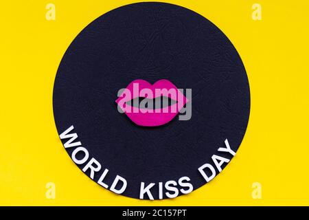 Words world kiss day or international kissing day. 6th July. Greeting card. Red lips on yellow background Stock Photo