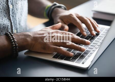 Closeup image african male hands typing on laptop keyboard Stock Photo