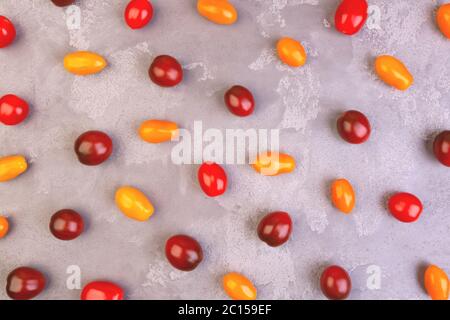Cherry tomatoes on gray marble background. Pattern. Stock Photo