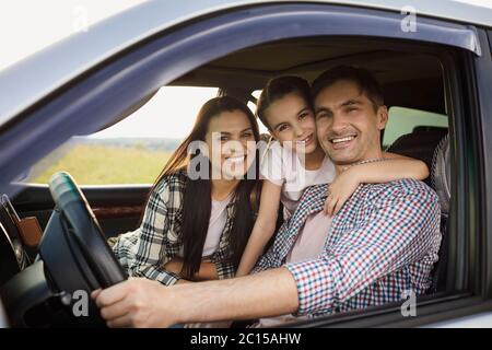 Happy family on the road in a car on an adventure vacation trip. Stock Photo