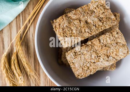 Cereal breakfast bars in breakfast bowl with wheat ears next to it - close up top view photo Stock Photo