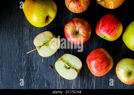 Red and green apples on a dark wood background - top view Stock Photo