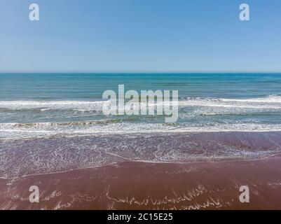 Aerial view of the sea waves from the coast to the horizon. The sky is clear. High quality photo Stock Photo