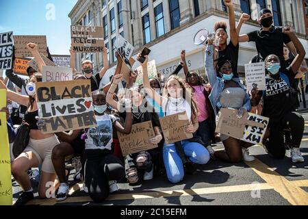 Brighton, UK. 13th June, 2020. A group of young people take a kneel in the street during the BLM protests in Brighton.Local activists in England organised a protest in the centre of Brighton in solidarity with the BLM protesters in the US to highlight the systemic racism and police brutality in the UK. Credit: SOPA Images Limited/Alamy Live News Stock Photo