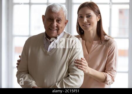 Head shot portrait smiling older man with grownup daughter Stock Photo