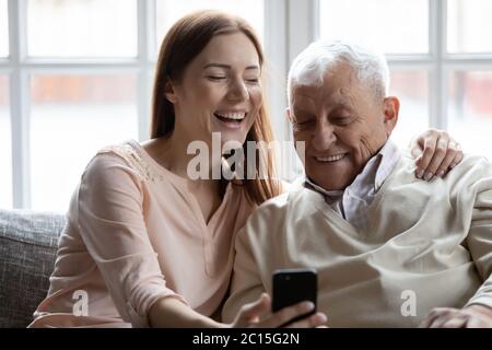 Close up smiling older man with grownup daughter making selfie Stock Photo