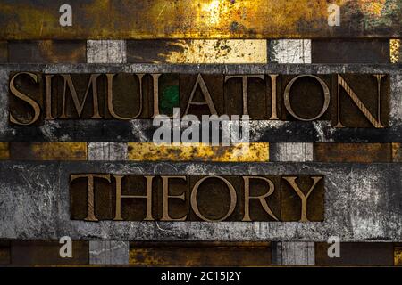 Simulation Theory text formed with real authentic typeset letters on vintage textured silver grunge copper and gold background Stock Photo