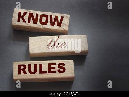 Know the rules word on wooden blocks isolated on dark grey background. business process regulation concept Stock Photo