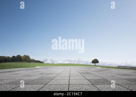 empty brick floor with white snow mountains Stock Photo