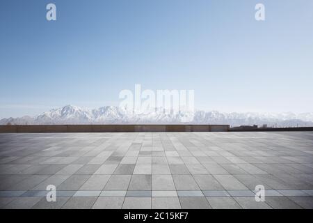 empty brick floor with white snow mountains Stock Photo