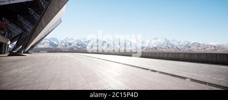 empty brick floor with white snow mountain Stock Photo