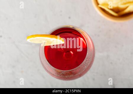 Snack with chips and green olives on grey concrete texture. from above, copy space. soft focus. Stock Photo